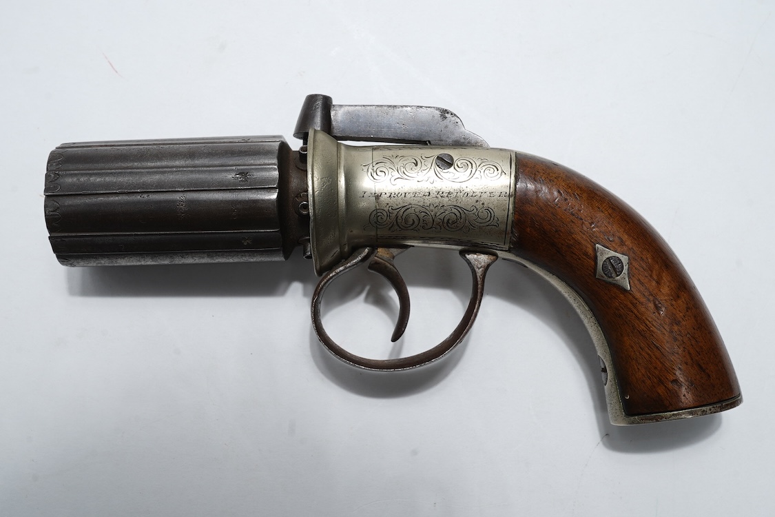 A six shot 120 bore self-cocking percussion pepperbox revolver with fluted barrels, Birmingham proof, rounded foliate engraved frame with ‘Improved Revolver’, and two-piece walnut grips